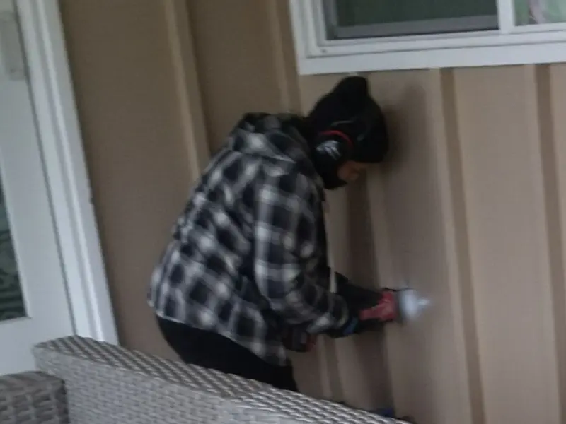 Professional electrician installing an exterior outlet in White Oak